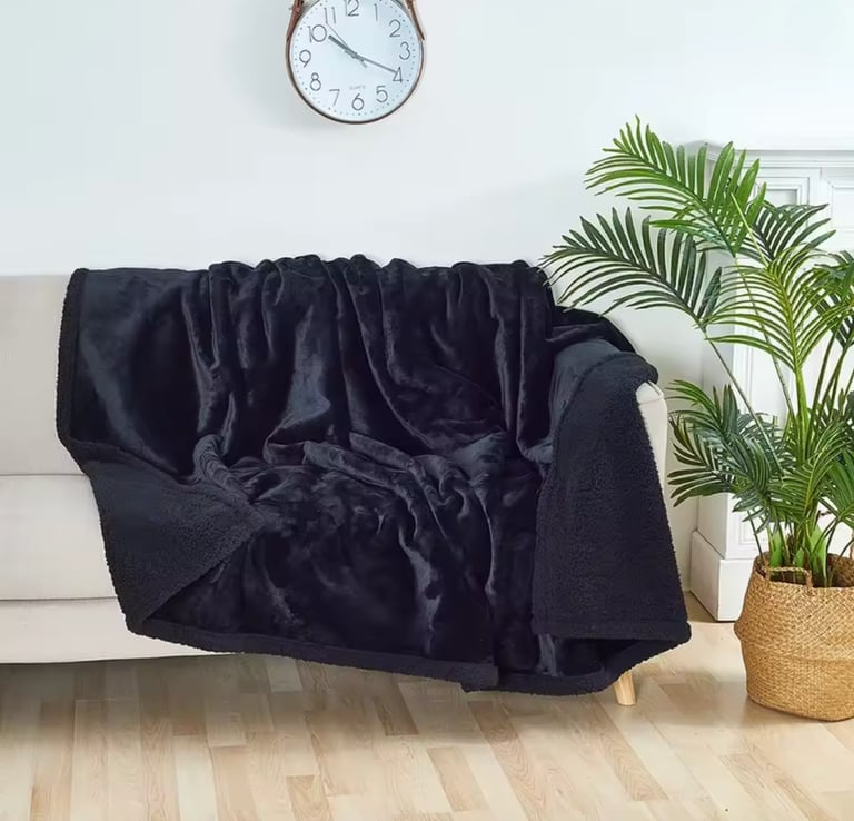 Soft plush throw on chair in cozy small bedroom corner