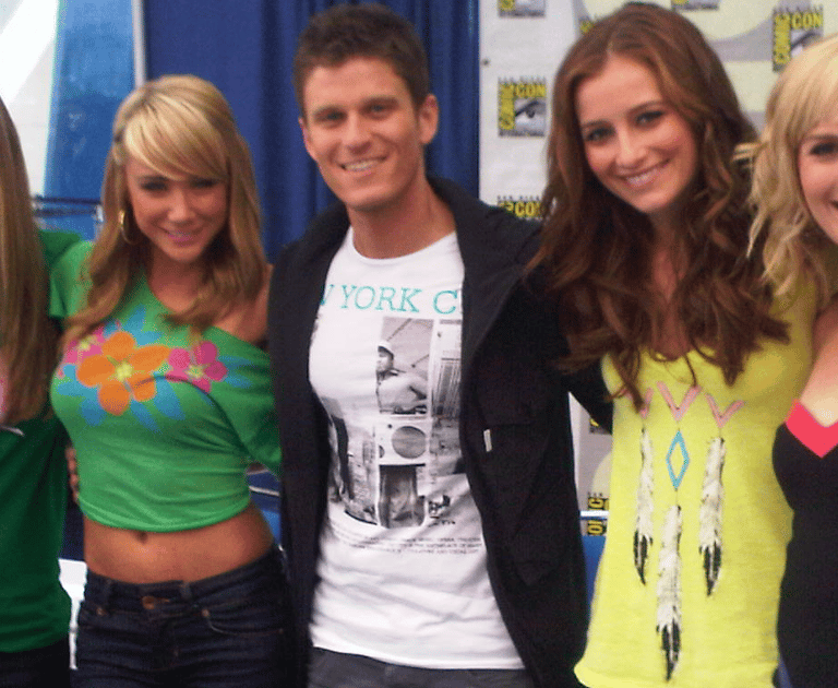 a group of people standing around a table