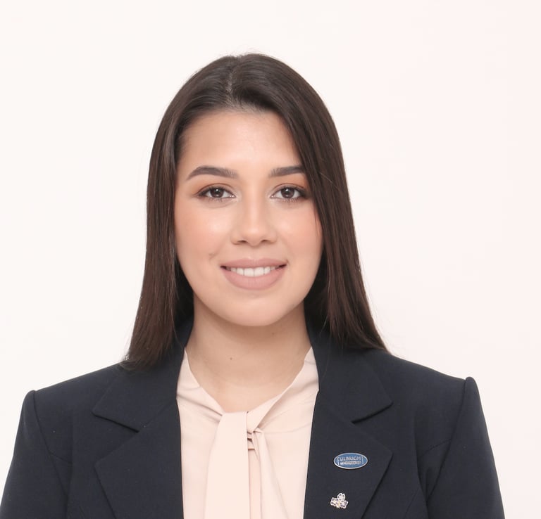 Headshot picture of Betania Locatti Macerno in a black blazer