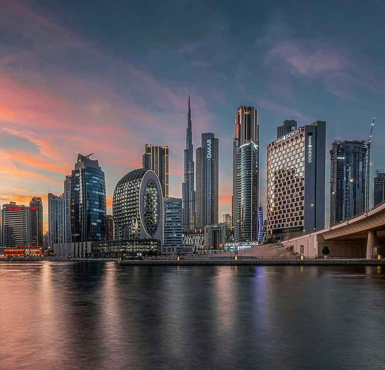 Dubai skyline at sunset with Burj Khalifa and Business Bay towers, representing global investors and family office access.