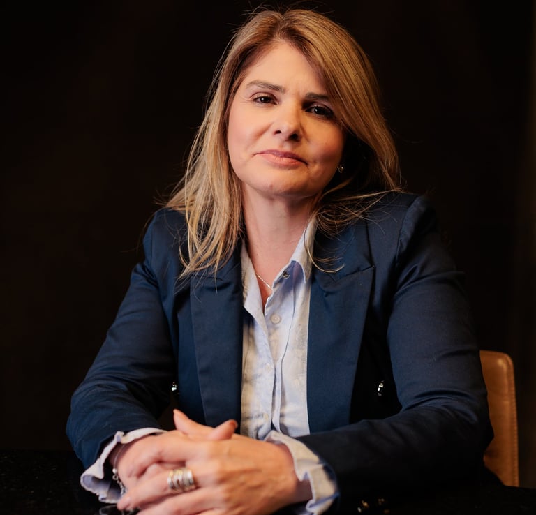 a woman in a suit and a ring on her finger