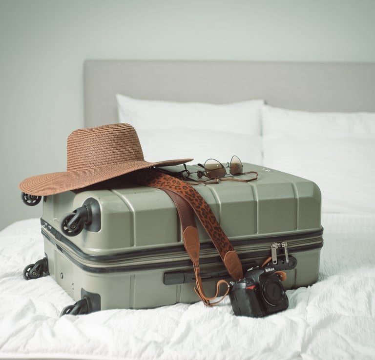 a hat and suitcase lying on bed of a hotel in costa rica