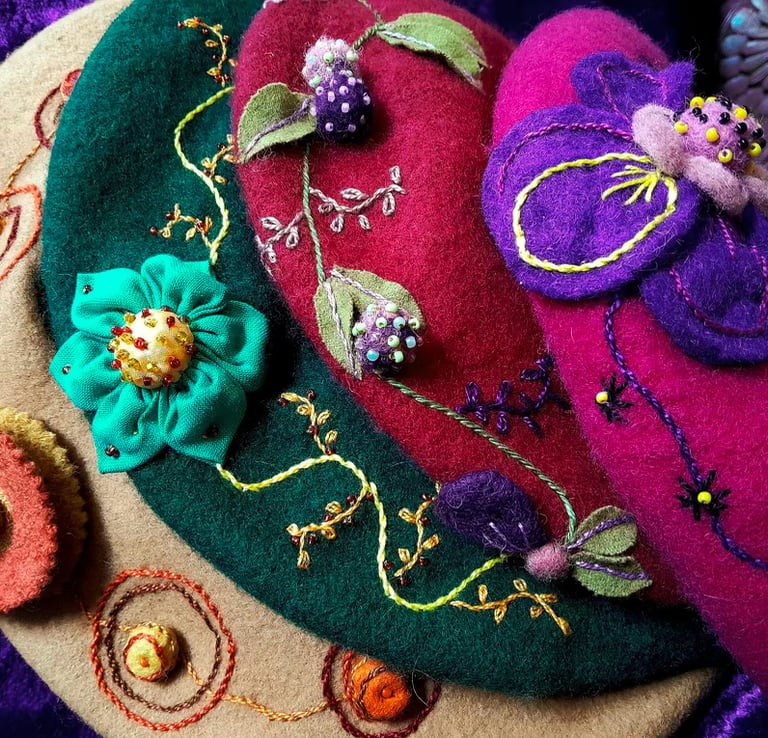 a group of colorful felt hats with flowers