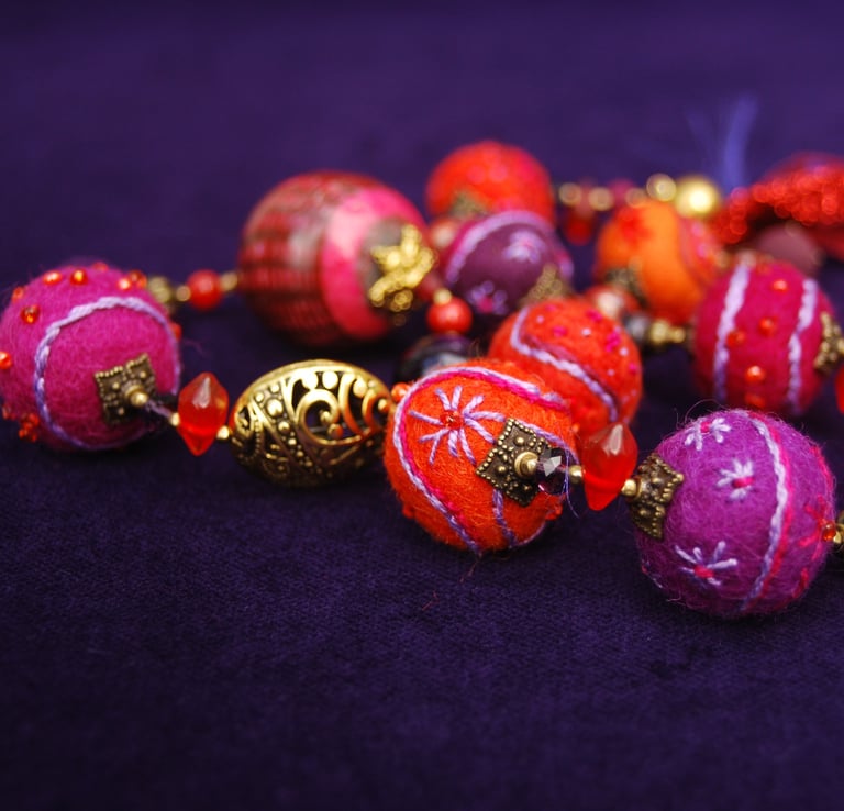 a bunch of beads and beads on a purple background