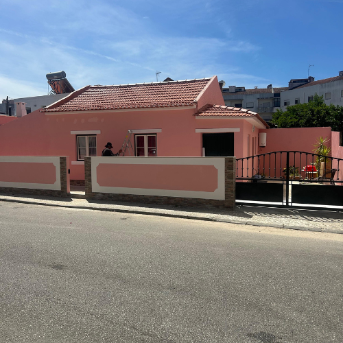 a pink house with a pink house in the background