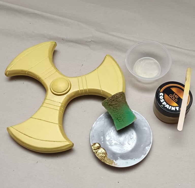 adding a smooth coat of gold paint on primed EVA foam