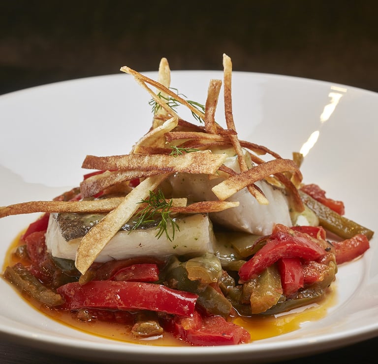 Seafood Dish – Fresh fish with roasted peppers and crispy potatoes.