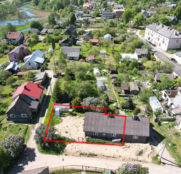 a large house with a red square shaped area in the middle of a small town