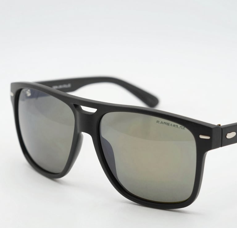 Sleek sunglasses resting on a smooth stone surface under natural light