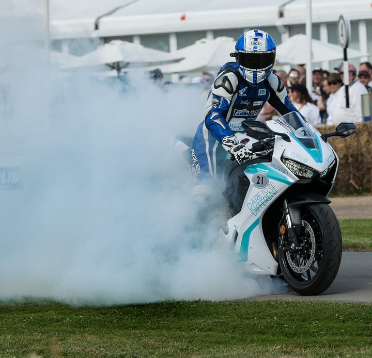 A biker doing a burnout at Goodwood