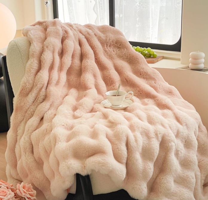 a pink blanketed Luxury blanket on a chair