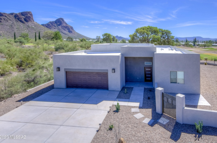 a house with a large driveway and a mountain view
