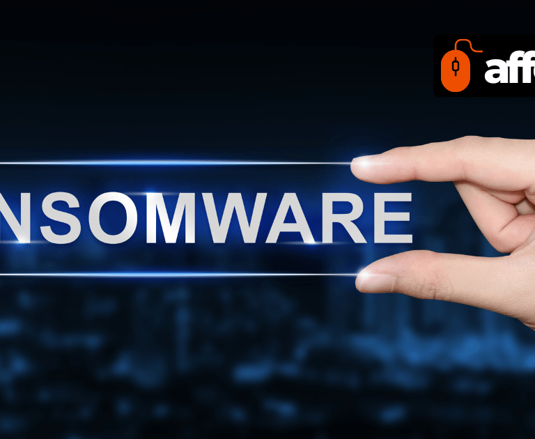 A hand grasping the word Ransomware representing cybersecurity threats and data protection services.