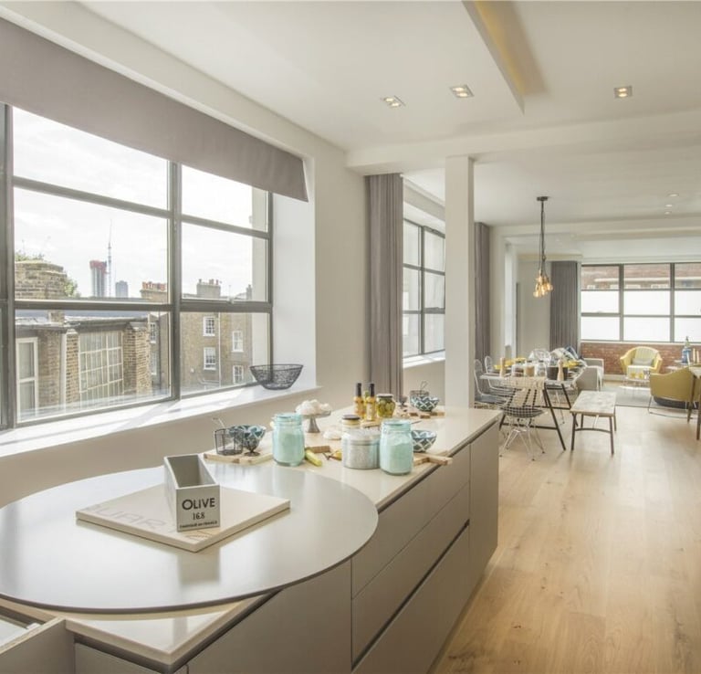 a kitchen with a large window and a table with a phone