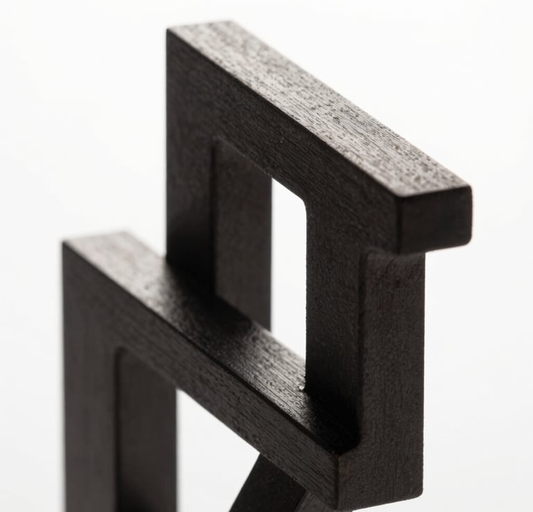 Abstract high-contrast 3D geometric structure, sharp metallic edges, dark charcoal and pure white lighting, studio background, macro shot, clean minimalist composition
