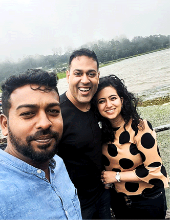 Friendly Sri Lanka driver opening car door for tourists during a private transfer