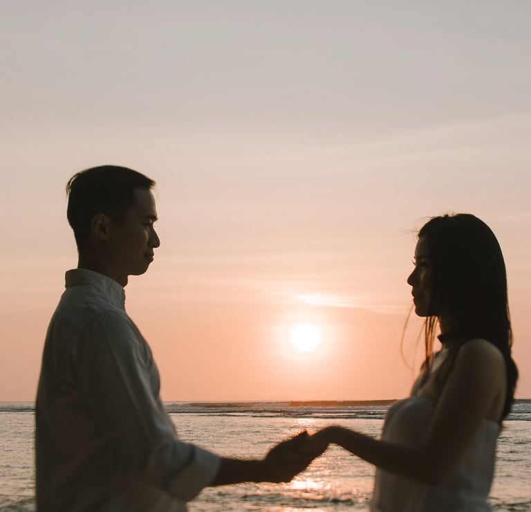 Silhouette couple holding hands at sunset during a proposal photography session at Anantara Uluwatu Bali Resort.