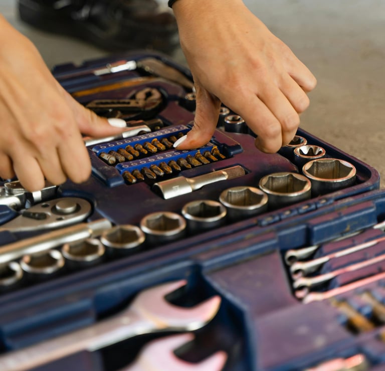 a person holding a tool kit in a toolbox dépannages