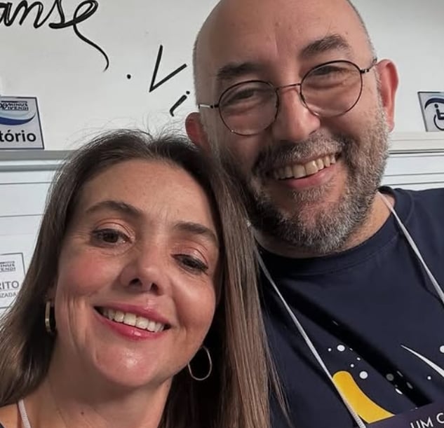 a man and woman smiling and posing for a picture
