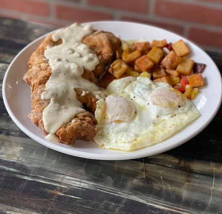 a plate of food with eggs and potatoes on it