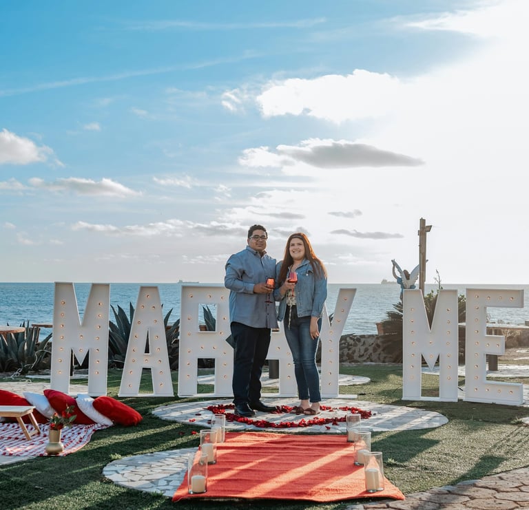 a man and woman standing in front of a sign that says marry me