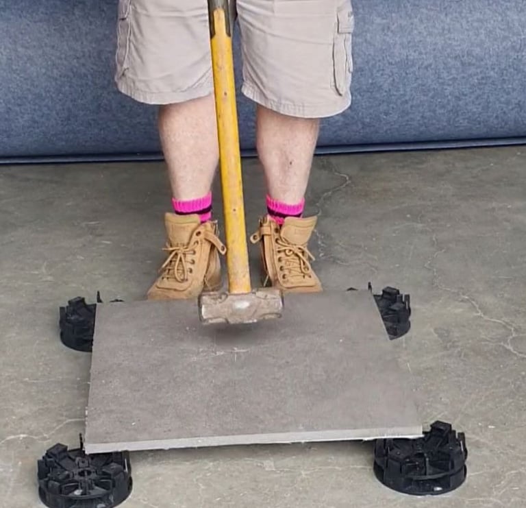 Hitting tile with sledgehammer