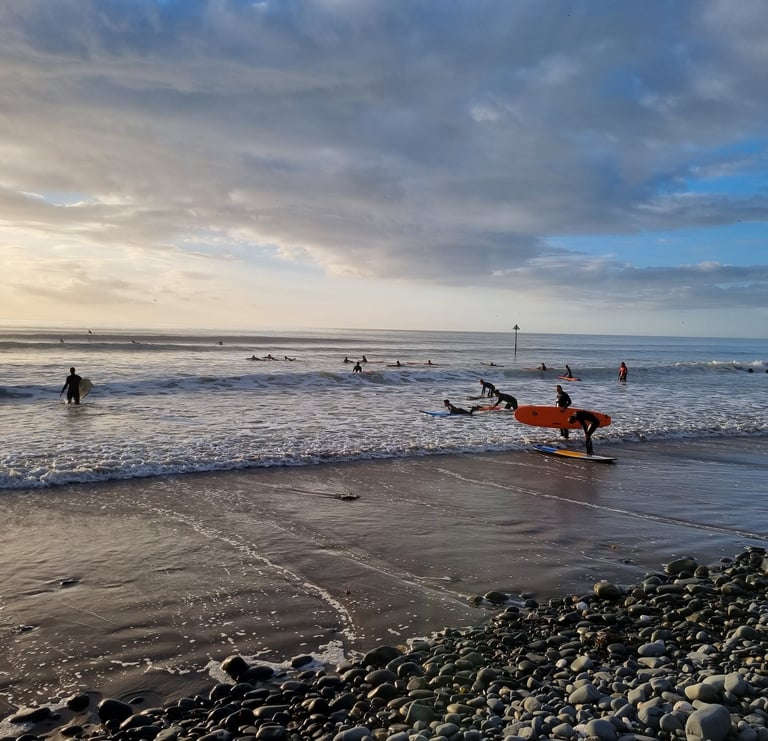 A busy surf lesson at Ynyslas with clean good waves and evening sunshine