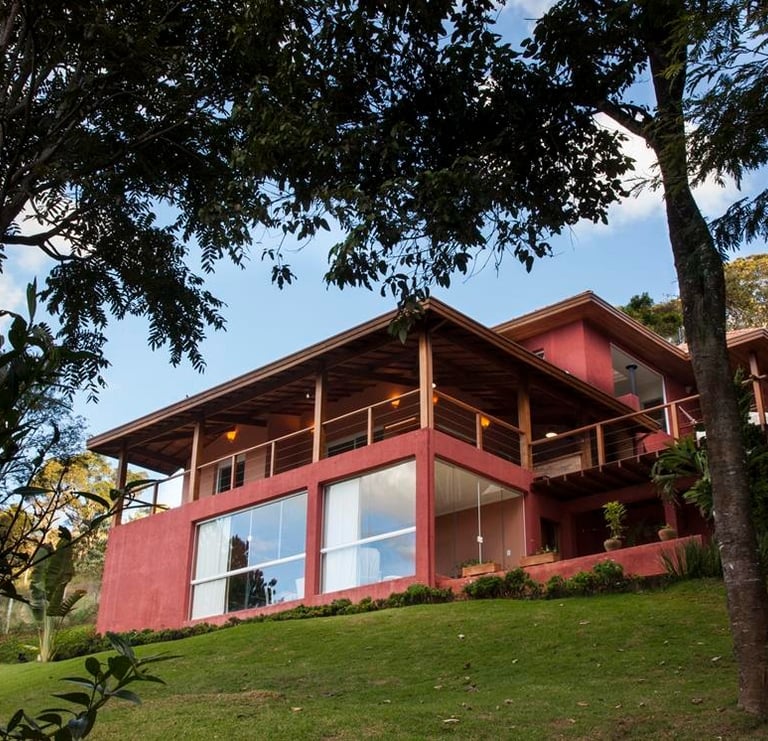 a house with a red exterior and a large window