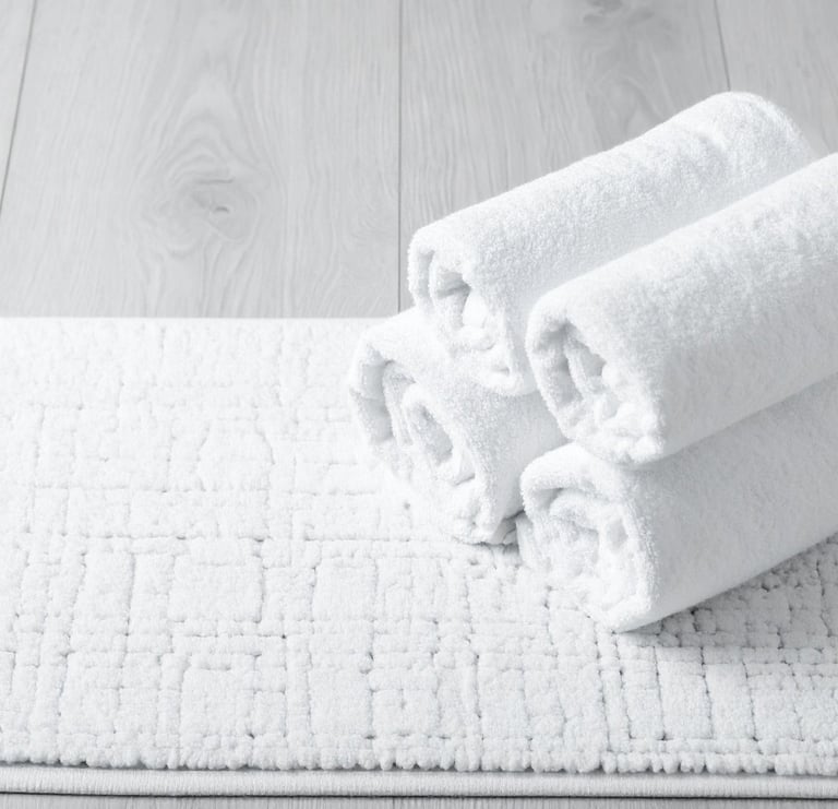 a pair of towels and a pair of towels on a white rug