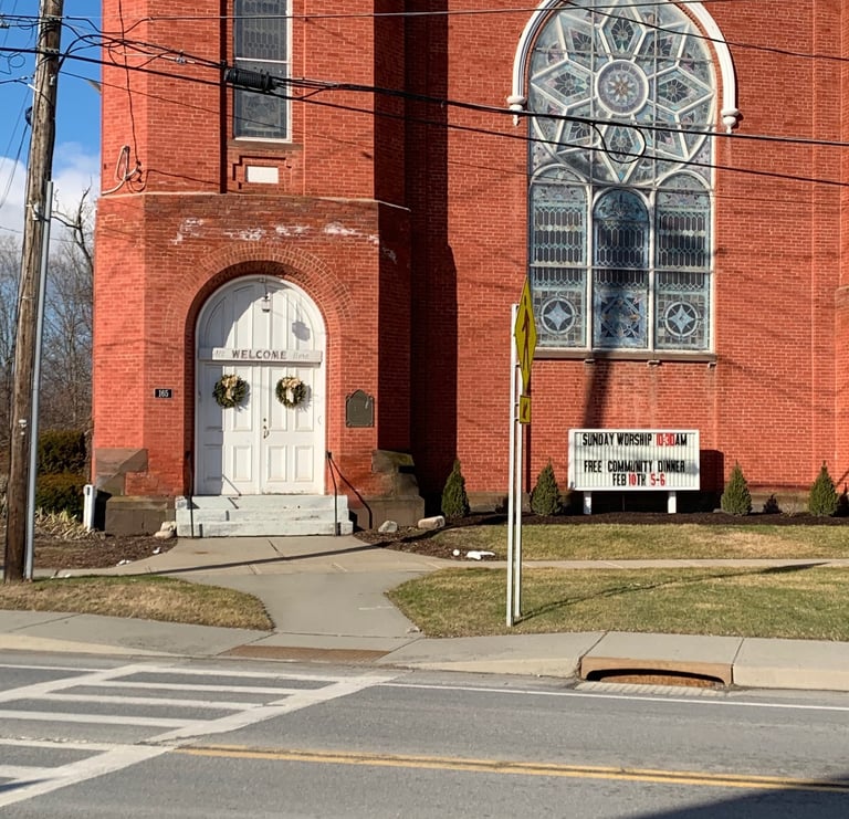 Image of the front of the Presbyterian United Church in Schaghticoke NY with "All are welcome" sign