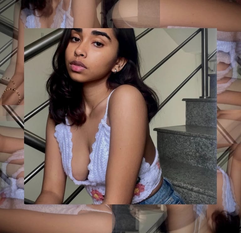 a woman in a white bra top and jeans shorts