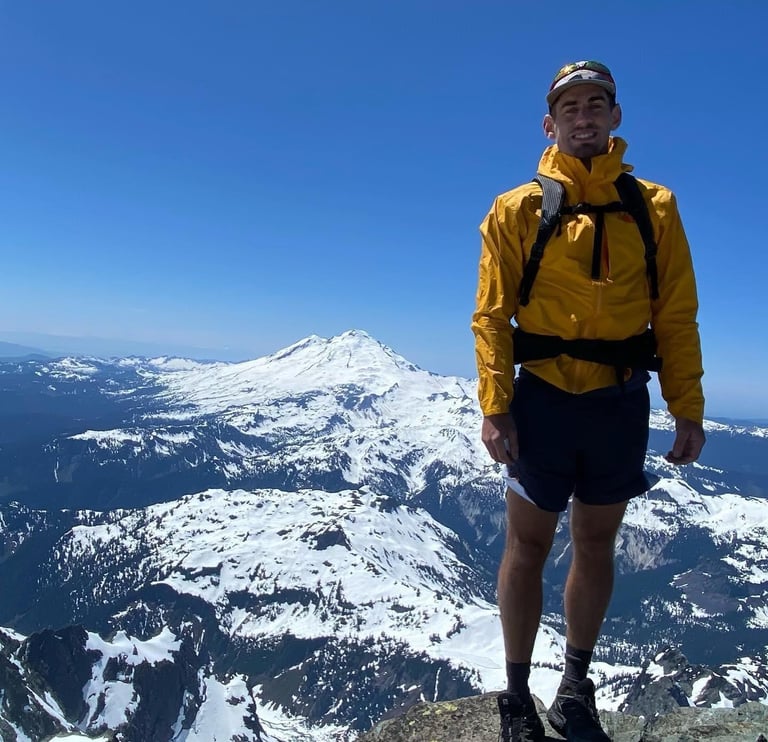 Noah Phillips standing on top of a mountain in Washington