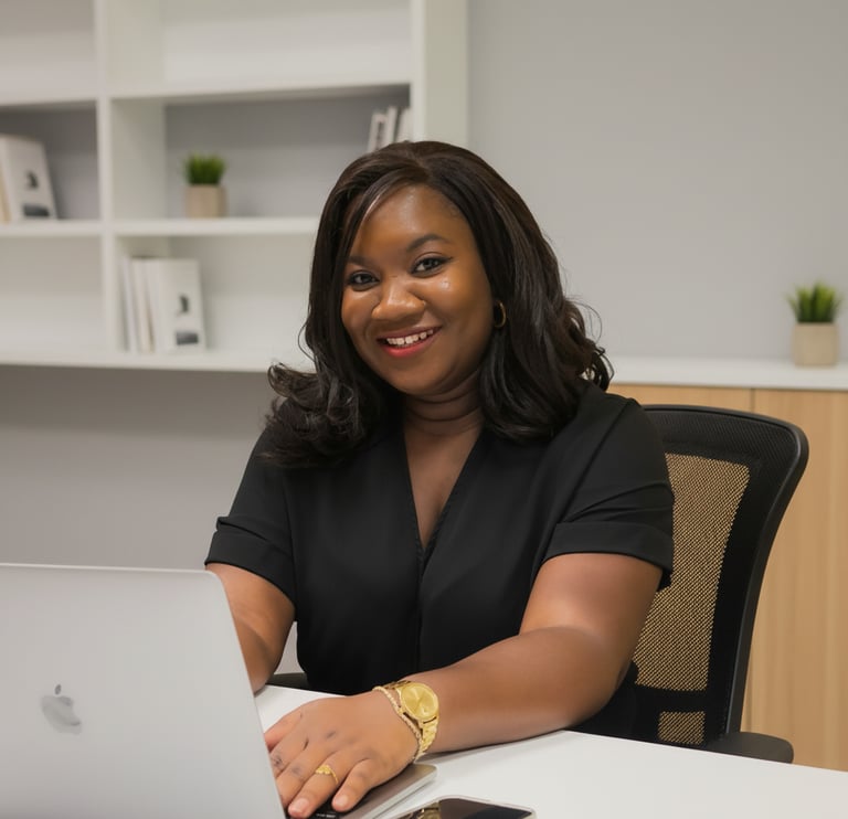 Angele Kasse, Founder of Local Ads Lab smiling and sitting in an office setting with a laptop