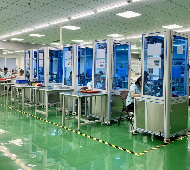 a factory floor with a lot of people working on machines