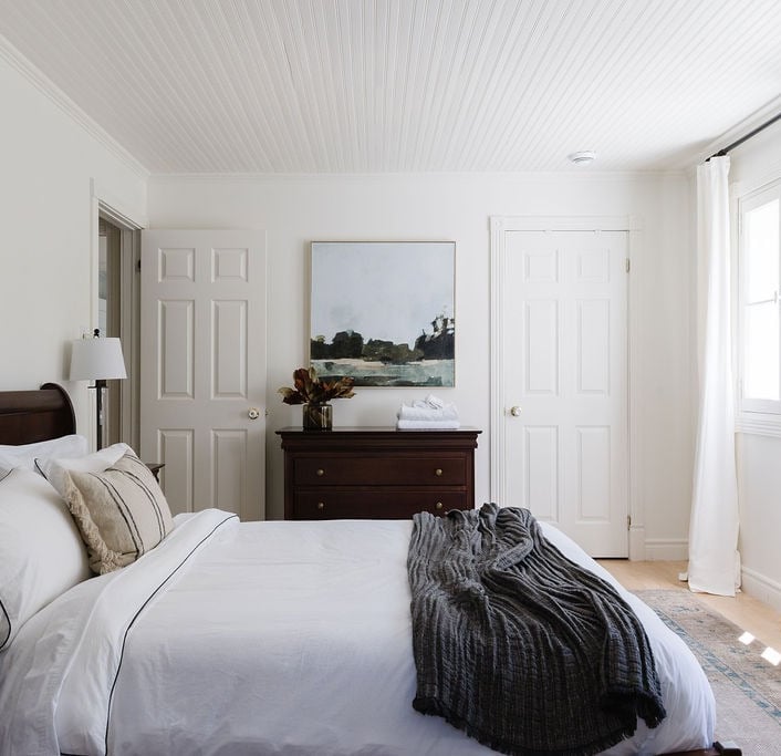a bedroom with a bed and a dresser