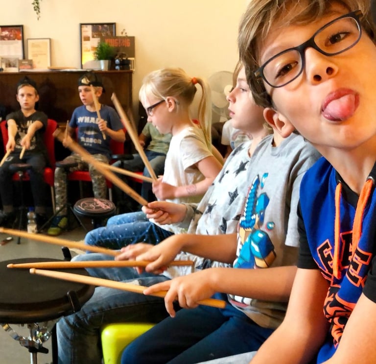 a boy playing drums in a classroom
