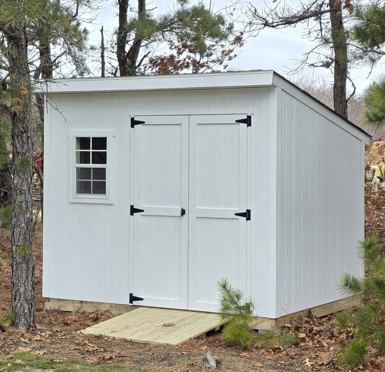 Custom-built 6x8 wooden shed with window, handcrafted in Halifax, Massachusetts for small outdoor spaces.