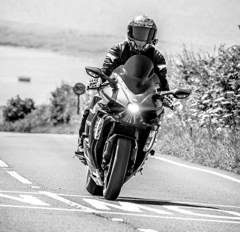 Motorcycle moving on a road and crossing a 'slow' marking