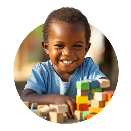 Child smiling with colourful blocks around him