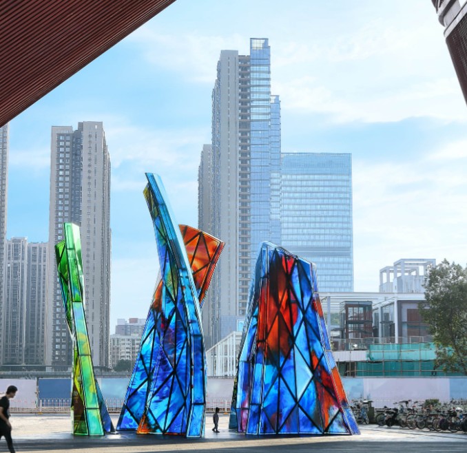 Blooming Sculpture by Shan Shan Sheng in the daytime with the city skyline behind it