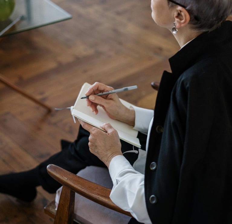 a woman sitting in a chair with a cat