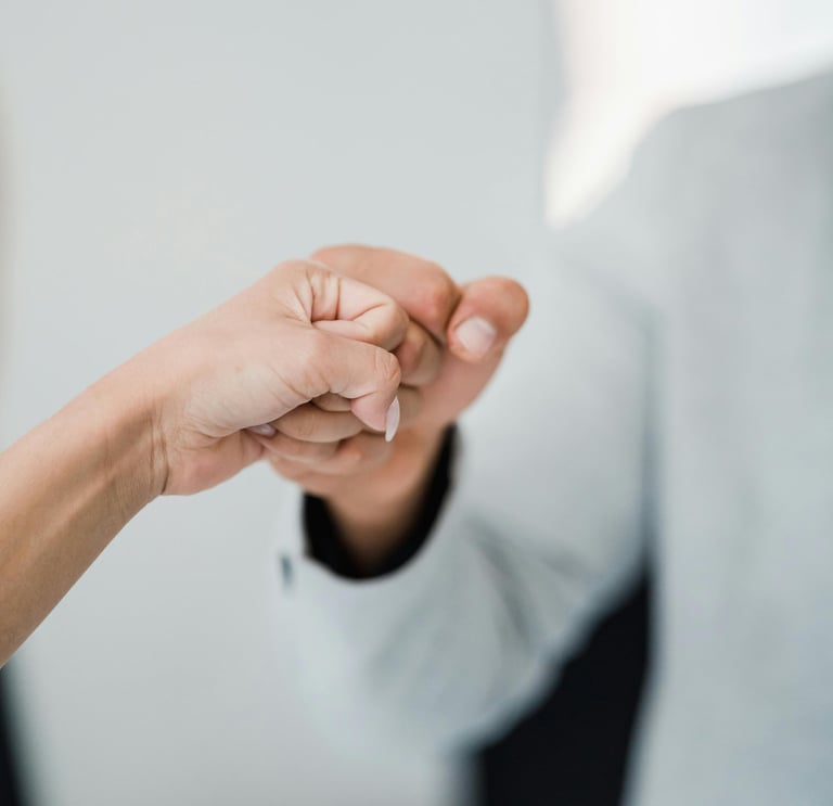 a man and woman holding hands in a meeting
