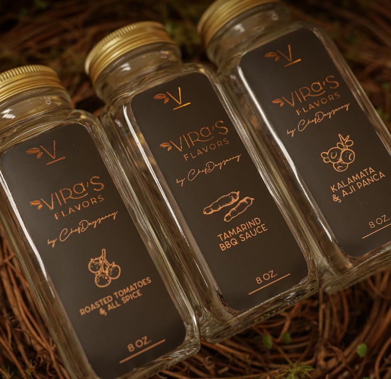 three bottles of sauce in a nest with a nest of grapes