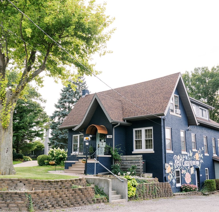 South Cliff Inn exterior, featuring the front door, mural, and parking lot