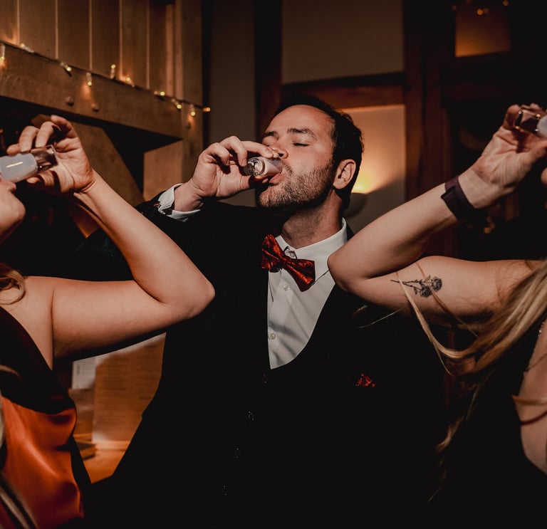 Bride and groom walking through gardens in Leeds – wedding photography by The Wedding Edit