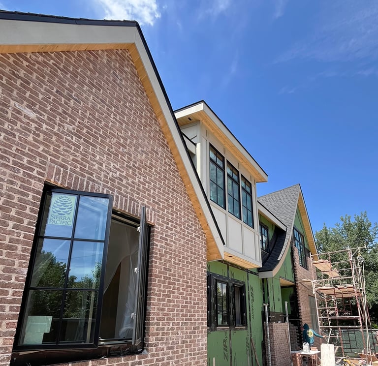 a brick building with a green door and a window