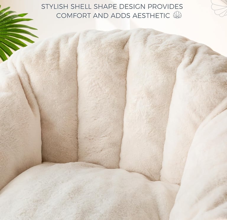 Cream shell-shaped chair cushion with soft faux fur texture for aesthetic home decor comfort.