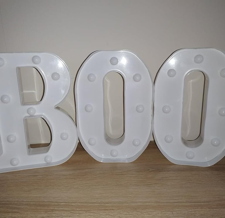 White LED marquee letters spelling "BOO" with glitter finish, perfect Halloween decoration for home,