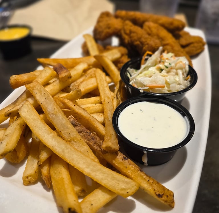 image of french fries, ranch, coleslaw, and chicken fingers from AppleBee's