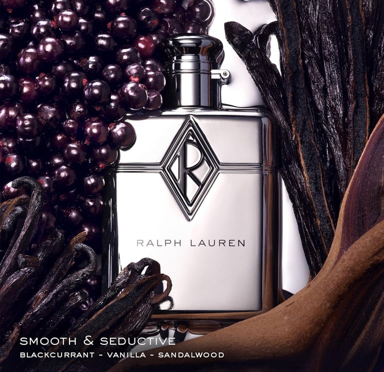Ralph Lauren silver perfume bottle surrounded by blackcurrant berries and vanilla beans.
